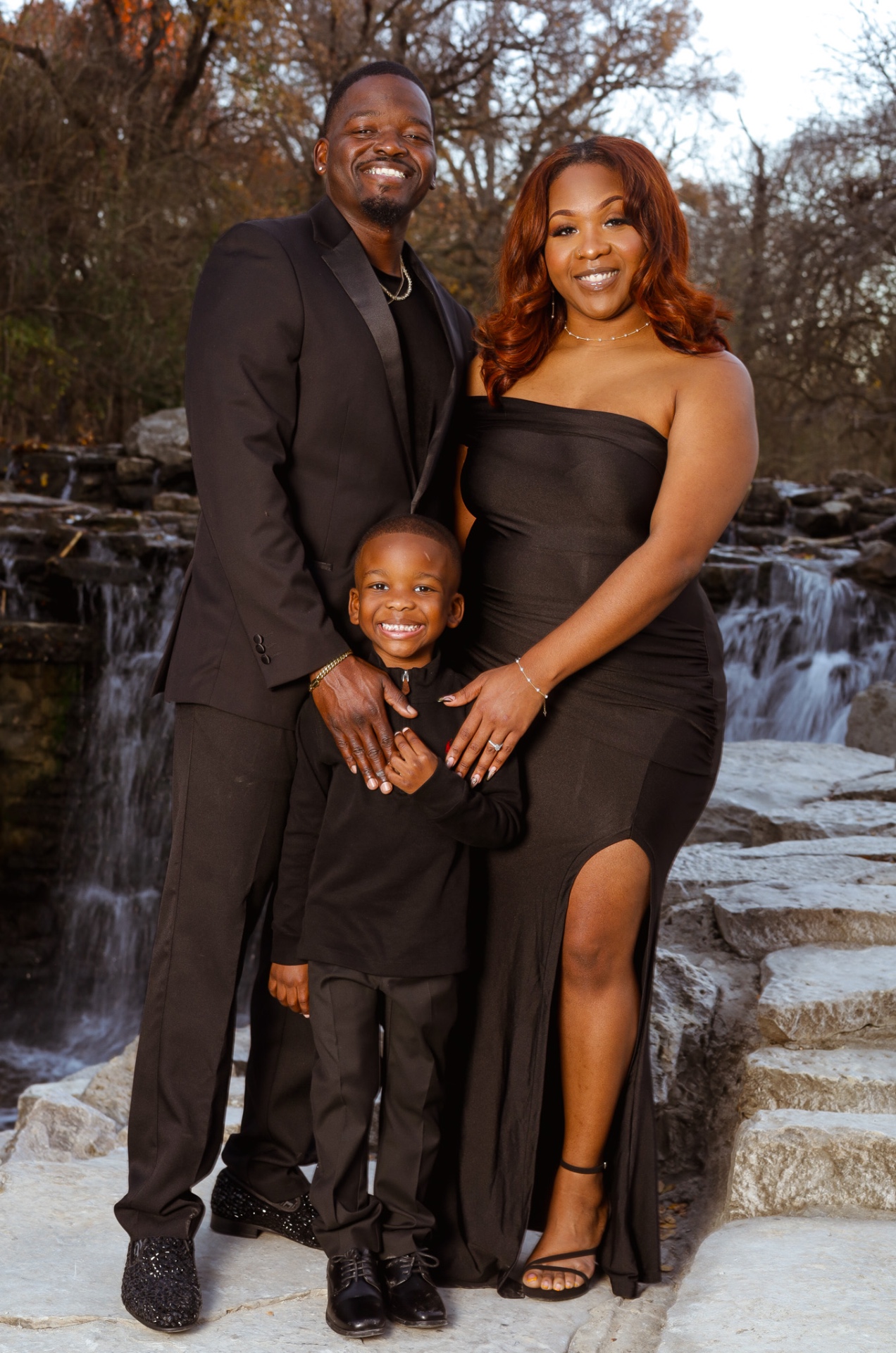 Family portrait at waterfall in matching black