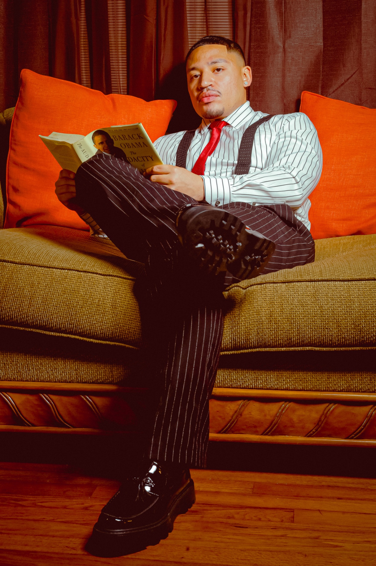 Editorial portrait of man reading on a couch