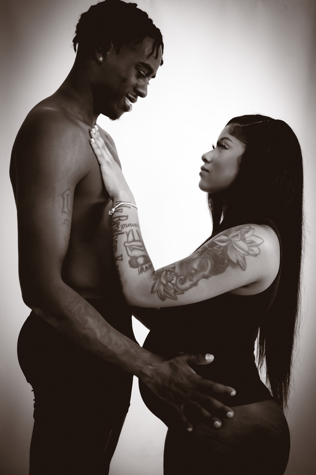 Black and white maternity portrait of expecting couple